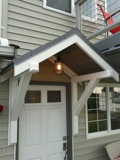 the front door of a house with a porch attached to it