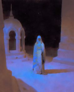 a woman dressed in white and blue standing on snow covered ground next to an archway