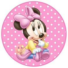 a minnie mouse sitting on top of a pink polka doted circle with a bow in it's hair