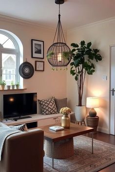 a living room filled with furniture and a flat screen tv on top of a wooden table