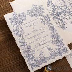 the wedding stationery is laid out on top of each other, including an envelope