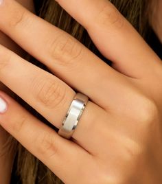 a woman's hand with a ring on it