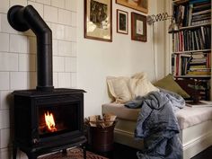 a living room filled with furniture and a fire place next to a book shelf full of books