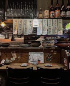 a restaurant counter with plates and bottles on it