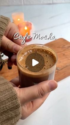 a person holding a cup of coffee in their hand with the caption cafe mocha