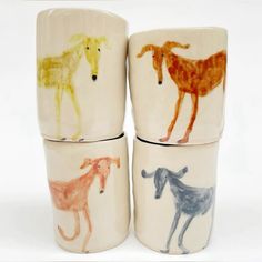 four cups with different colored horses painted on them