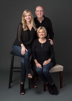 two people sitting on a chair posing for a photo