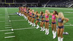 the cheerleaders are lined up on the field