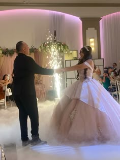 a man and woman dressed in wedding gowns dancing