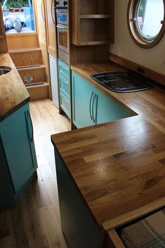 a kitchen with wooden floors and blue cabinets