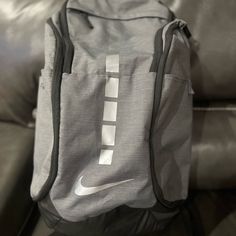 Nike Unisex-Adult Elite Backpack With Run Vest * Large, Zippered Main Compartment Provides Space For Your Gear. * Ventilated Shoe Compartment Can Hold Up To A Size 15. * Nike Pro Adapt Shoulder Straps Provide Comfort. * Zippered Foil-Lined Pocket Offers Space For Your Favorite Beverage Gray Nylon Rectangular Backpack, Gray Rectangular Nylon Backpack, Casual Gray Backpack For Sports, Casual Gray Sports Backpack, Functional Gray Backpack, Rectangular Gray Gym Bag, Gray Sports Bags With Zipper Closure, Gray Nylon Backpack For Sports, Functional Gray Backpack For Sports