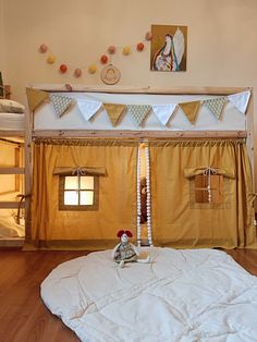 there is a bed in the room with two bunk beds and a stuffed animal on it