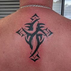 a man with a cross tattoo on his back