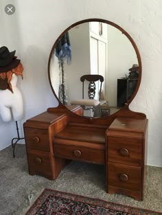 a mirror sitting on top of a wooden dresser