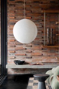 a living room with a large white ball hanging from the wall next to a couch