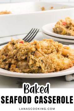 baked seafood casserole on a white plate with fork and serving dish in the background