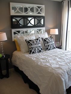 a white bed sitting in a bedroom next to two lamps on either side of the bed