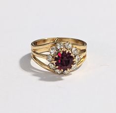 Sparkling Garnet Austrian Crystal Ring in floral design Gold HGE from the estate market.  The beautiful high-quality ring is shining like real gold  Size 7 1/2 adjustable  in excellent vintage condition no tarnish It will arrive in a gift box! Clean Smoke and pet-free home studio. Please feel free to look at the other items I hope and believe you will find something else that will like and interest you. My Store https://www.etsy.com/shop/Jelifem Rose Gold Moonstone Ring, Gold Moonstone Ring, Snowflake Ring, Swarovski Crystal Rings, Almandine Garnet, Mother Rings, Purple Rhinestone, Rhinestone Ring, Crystal Ring