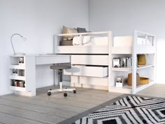 a bedroom with a bed, desk and bookcases on the floor in front of it