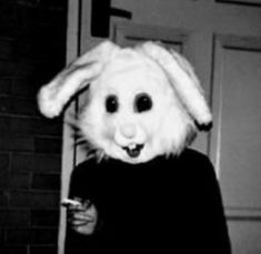 a person wearing a bunny mask and black shirt