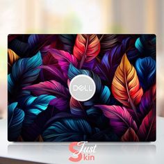 the dell laptop has been painted with colorful leaves on it's back and sides