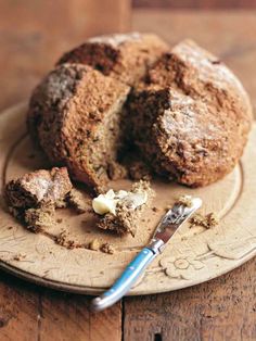 a muffin on a plate with a bite taken out of it