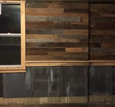 a wooden wall with metal siding and a window