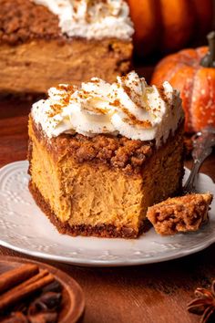 a slice of pumpkin pie on a plate with a fork and cinnamon spicer in the background