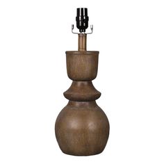 a brown vase with three black candles on it's top and one candle holder in the middle