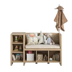 a stuffed animal sitting on top of a wooden bench next to a book shelf filled with books