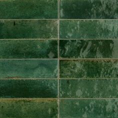 a green tile wall that has been cleaned and stained with some dirt on it's side