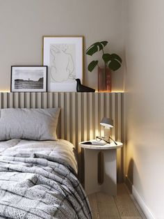 a bedroom with a bed, side table and pictures on the wall above it that have been placed next to each other