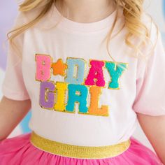 The Birthday Girl Patch Short Sleeve T-Shirt is a fun and festive t-shirt for celebrating the birthday girl! Features: Shirt Color: Ballet Pink Patch Color: Multicolor chenille with gold glitter outline Material: 100% Cotton Features: Tagless inside neck label for an itch-free wear Fit: Toddler Unisex; True to Size Care: Machine washable, wash inside out, lay flat to dry, wash with like colors Each t-shirt is hand pressed with love in our hometown warehouse. Music Dress, Girl Patches, Pink Patch, Knit Baby Dress, Patches Shirt, Baby Journal, Boy Onesie, Baby Boy Onesies, Ballet Pink