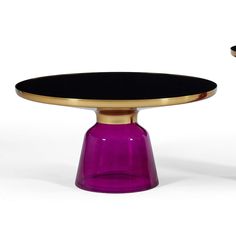 two purple vases sitting next to each other