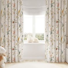 a white teddy bear sitting on top of a window sill next to a stuffed animal