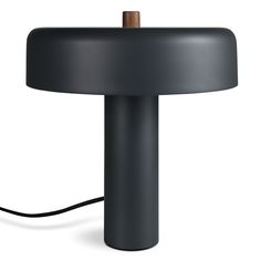 a black table lamp with a brown cord