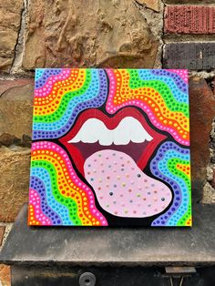 a colorful painting of a woman's lips on a brick wall