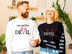 👻 Get Your Spooky Season Started in Style with Halloween Couple Matching Shirts and Sweatshirts! 🎃 Celebrate Halloween with your partner in these fun, witty matching couple shirts or cozy sweatshirts! The men's shirt or sweatshirt proudly declares "I Put The D in DEVIL," while the women's simply says "DEVIL" - a playful, cheeky combo perfect for couples who want to make a statement this spooky season. Whether you're attending a Halloween party, trick-or-treating, or just enjoying some festive Halloween Matching, Halloween Couple, Matching Halloween, Couples Sweatshirts, Couple Shirt, Matching Couple Shirts, Sweatshirt Halloween, Matching Couple, Couple Matching