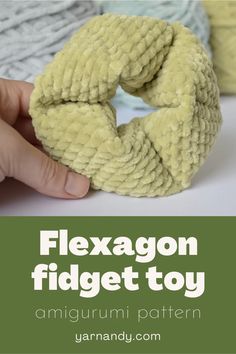 a close up of a person's hand holding a knitted object with text overlay that reads flexagon fidget toy