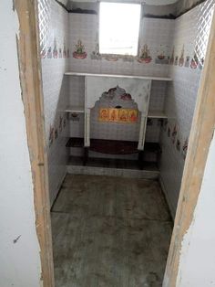 the inside of a small bathroom with tile walls and flooring, including a window