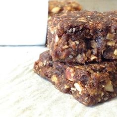 three granola bars stacked on top of each other next to a small white card