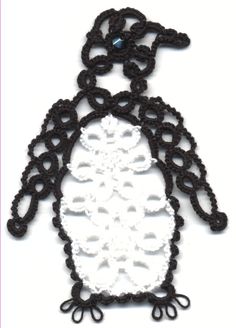 a white and black penguin is made out of crocheted yarn with an intricate design