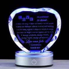 an illuminated heart shaped plaque with the words love is patient