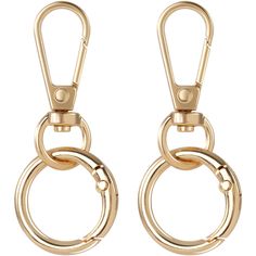 two gold colored metal rings hanging from hooks on a white background with clippings