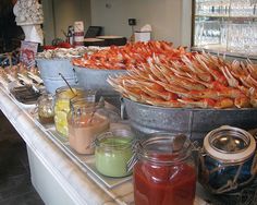 there are many different types of food on the counter at this restaurant that is ready to be eaten