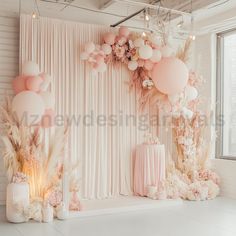 a room decorated with balloons, flowers and other decorations for a wedding or baby shower