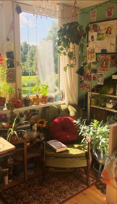 a living room filled with lots of plants and furniture next to a large open window