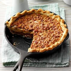 a pie sitting on top of a pan with a slice taken out of it's side