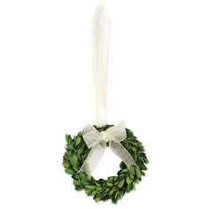 a wreath with a white bow hanging from it