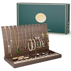 a wooden jewelry box with necklaces and bracelets